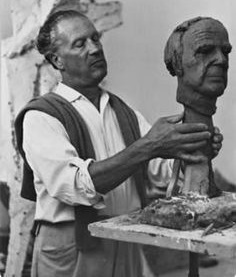 Marino Marini working the clay